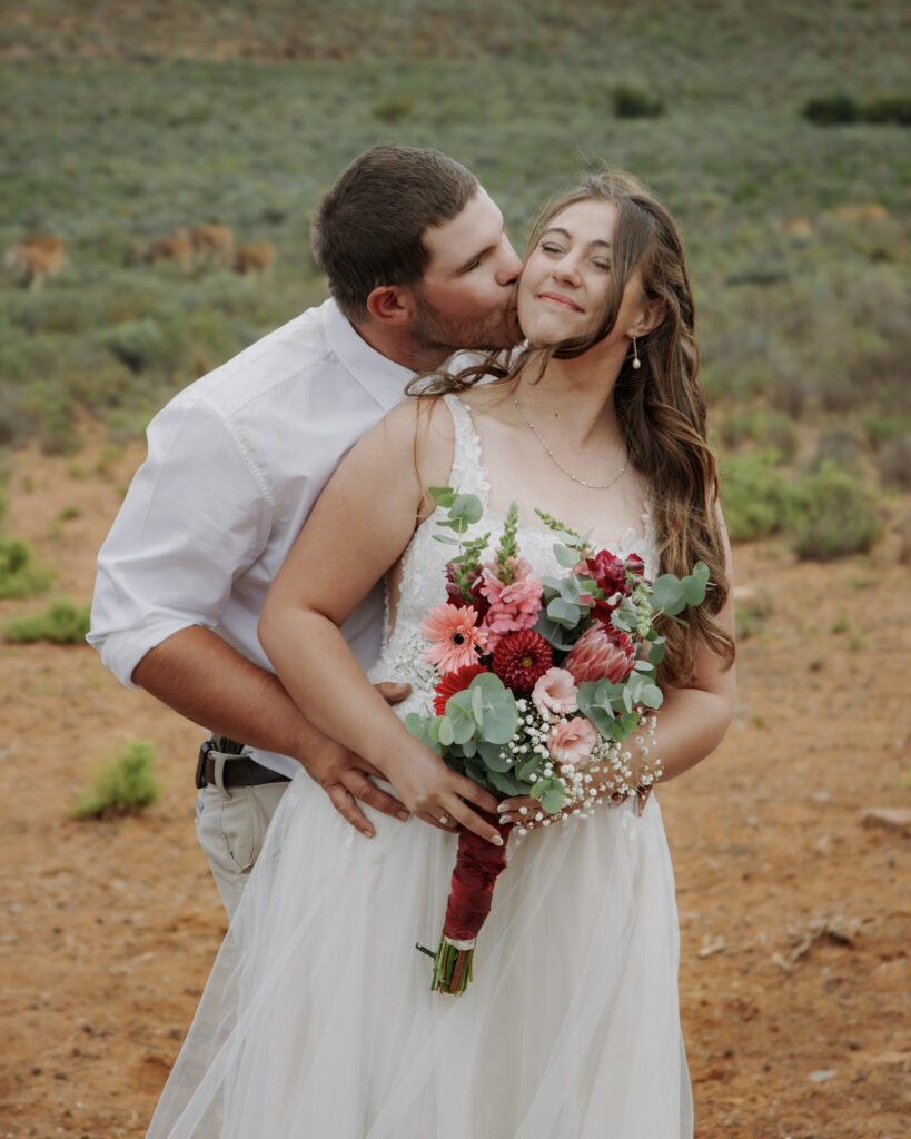 Wedding couple sharing a moment in a field